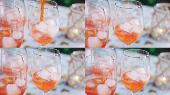传统的意大利Aperol Spritz露天派对下，调酒师将Aperol倒入加冰块的酒杯中，清爽的Ap
