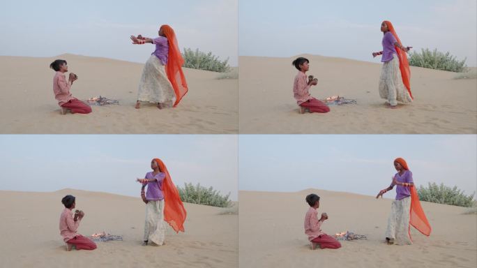 快乐的印度女孩在沙丘上跳舞，沙漠村庄，印度