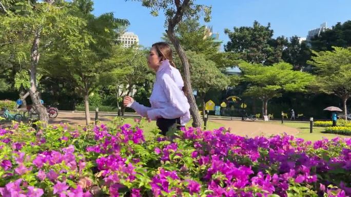 慢动作亚洲运动女子在城市公园跑步。