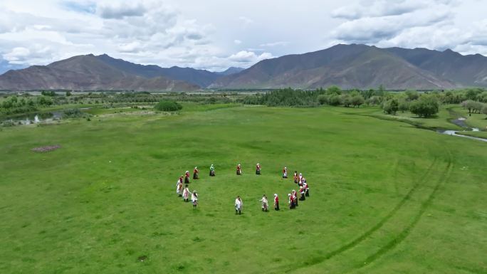 在草地上跳锅庄的藏族同胞