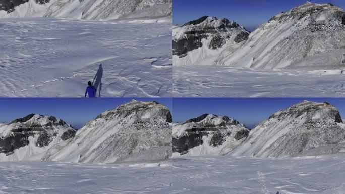 航拍人拿着滑雪装备在长白山雪山行走2