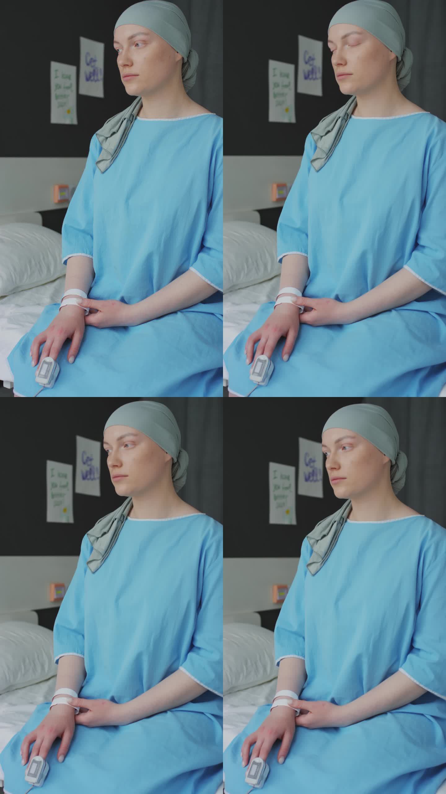 悲伤的肿瘤病人手指上戴着医疗器械坐在床上