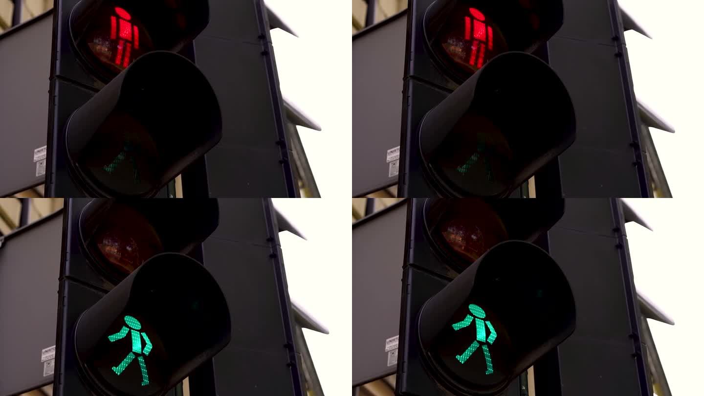 大型城市十字路口红绿灯特写，调节行人在街道上的移动，使道路上的人安全移动。道路设备交通管制。交通灯变