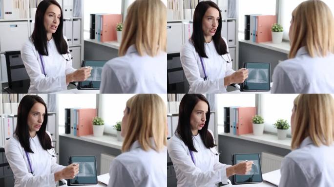 医生向病人展示数码平板电脑和肺部的CT扫描