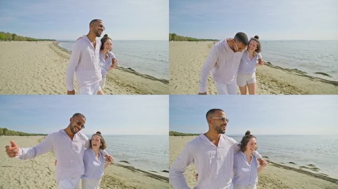 一对年轻的夫妇在阳光明媚的日子里微笑着走在沙滩上