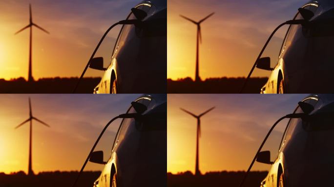 汽车充电和风车是在日落时看到的背景