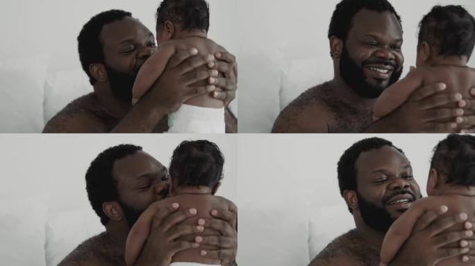 非洲父亲在家里抱着他的孩子。