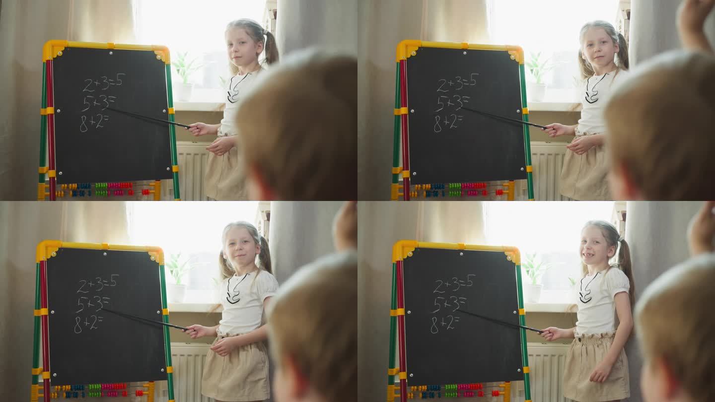 女孩让小弟弟在黑板上做数学题