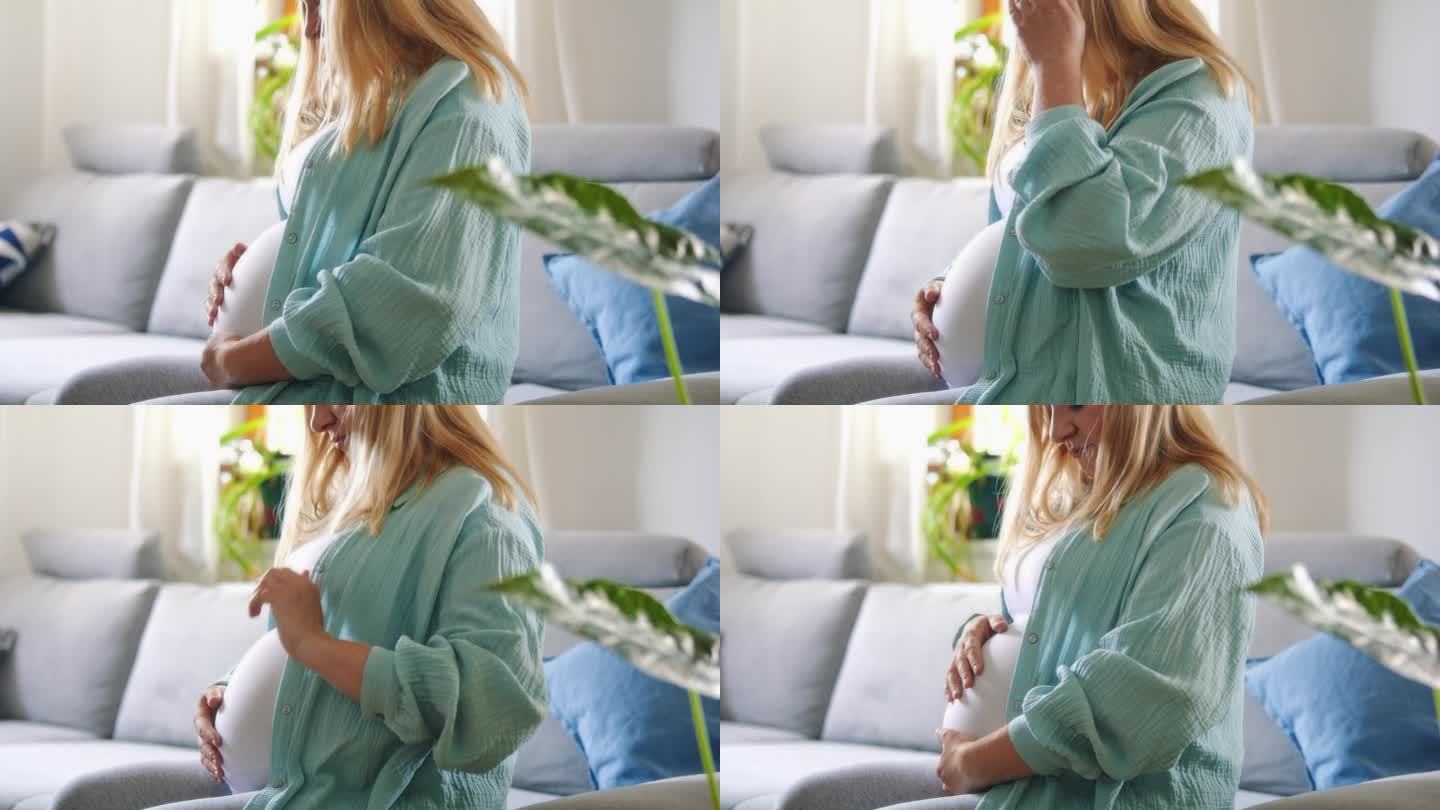 一位孕妇在客厅的沙发上轻轻地按摩宝宝的肚子