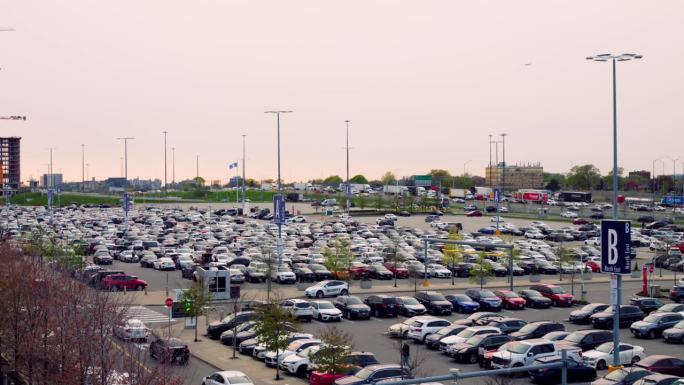 白天，商业中心、购物中心、超市旁停车场的俯视图。广阔的视野，拥挤的停车场，许多汽车在购物后等待着他们