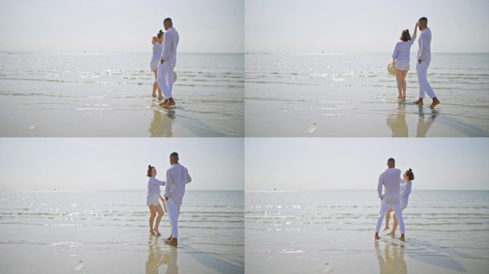 阳光明媚的一天，一对情侣赤脚在沙滩上跳舞