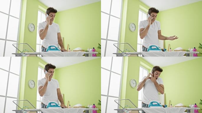 年轻的西班牙裔男子用智能手机在洗衣房用熨烫机烧衣服