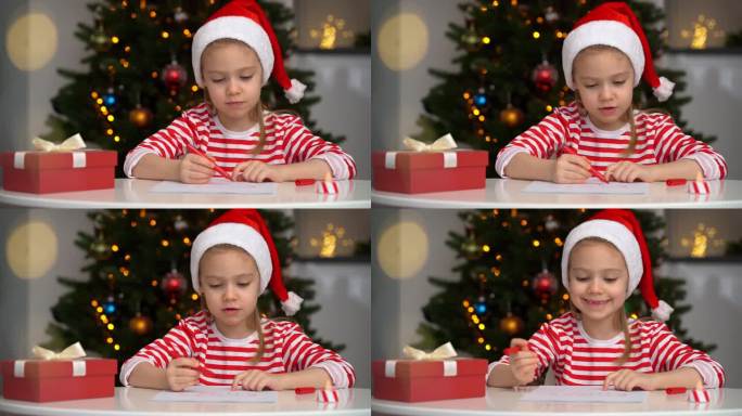 快乐的小女孩在圣诞树的背景下给圣诞老人写信
