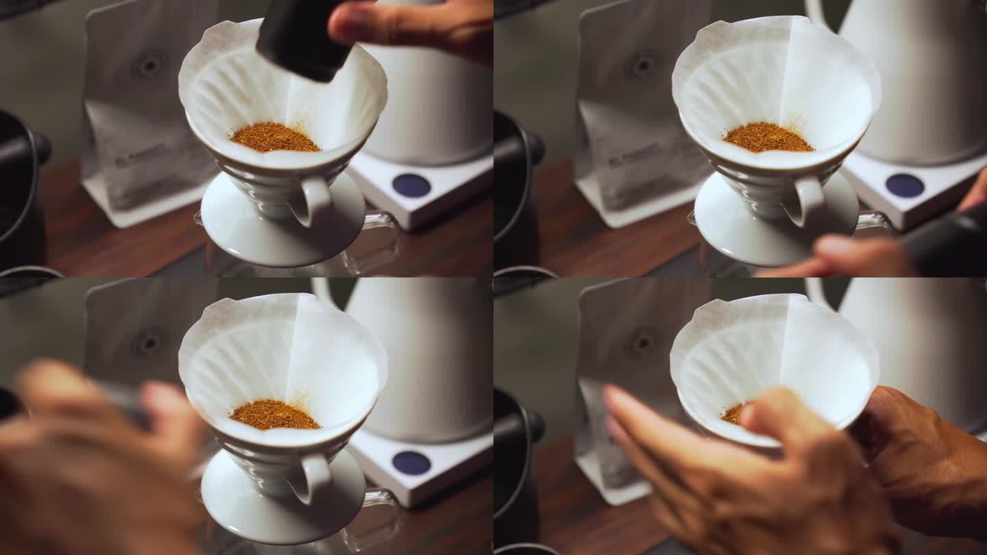 咖啡师将刚磨碎的咖啡倒入带有纸质过滤器的陶瓷滴管中