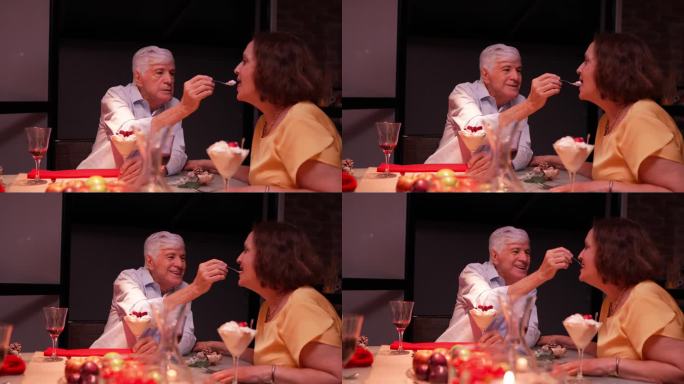 在家吃饭时，老人把食物放到妻子嘴里