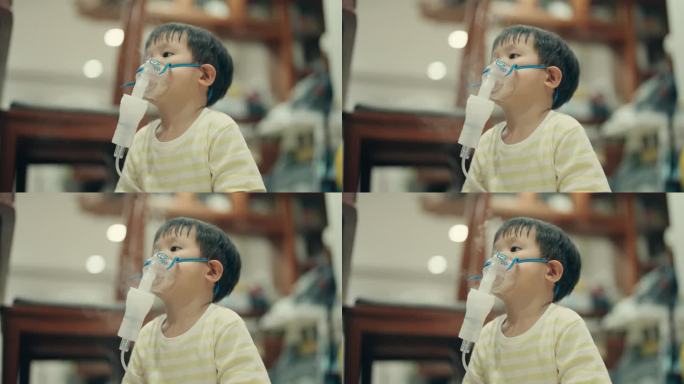 儿童保健:小亚洲男孩接受雾化吸入治疗。