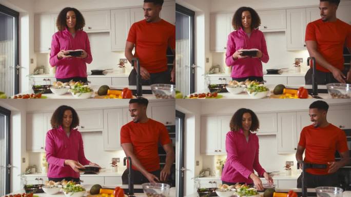一对穿着健身服的夫妇在厨房里提前做了一批健康的饭菜