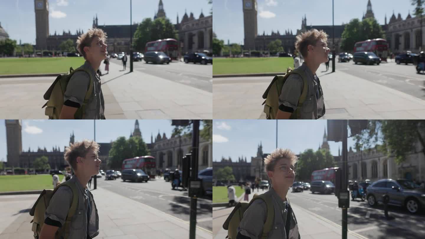 一个十几岁的男孩走在英国伦敦大本钟附近的议会广场花园
