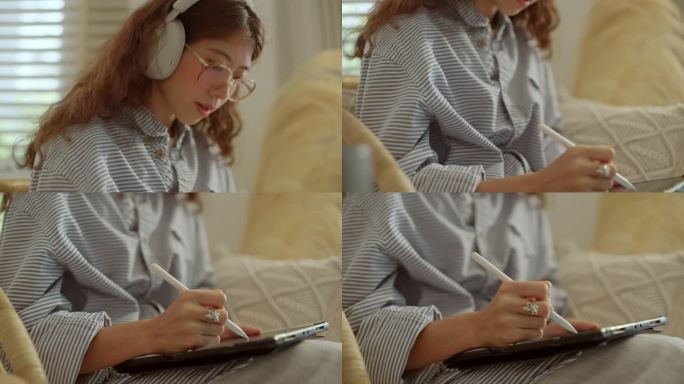 坐在家里客厅沙发上用数码平板电脑学习的女人的手