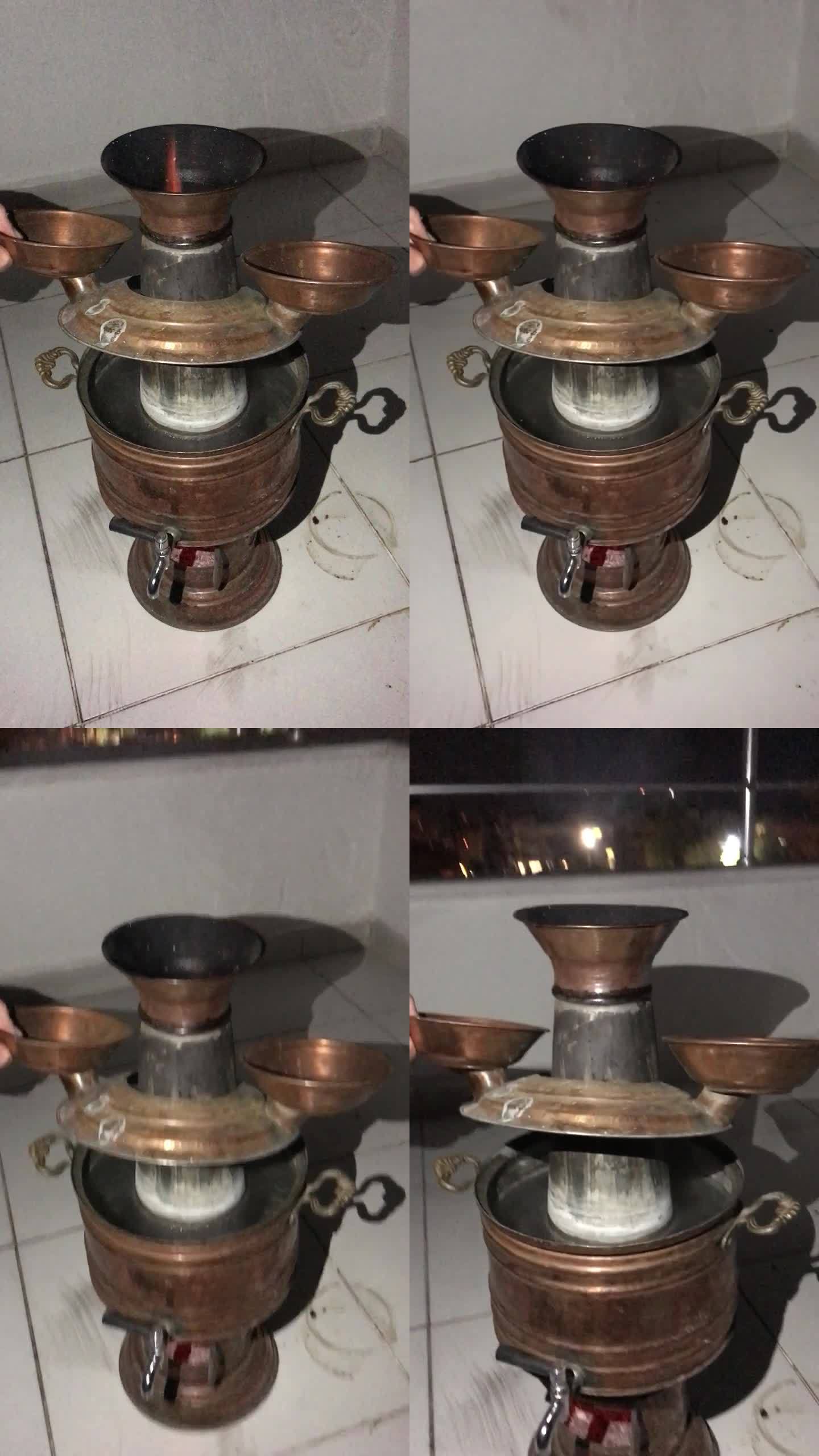 木头上的土耳其茶炊。可以看到热量和火焰。抬起肠道，检查水的加热。外面是晚上。垂直视频。