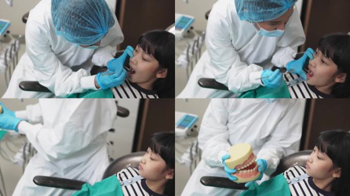 女牙医在牙科诊所拿着牙齿模型和孩子说话。
