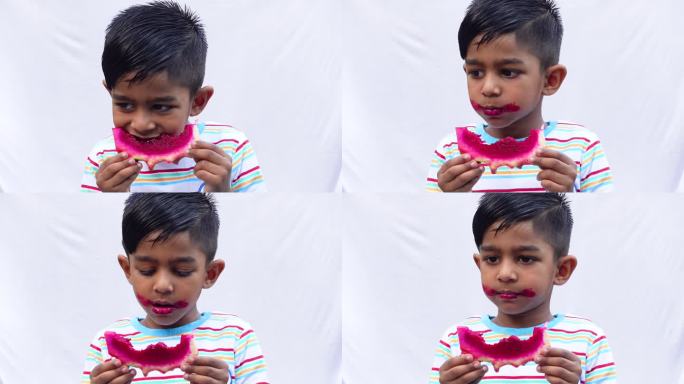 一个亚洲孩子正在吃一片粉红色的火龙果，背景是孤立的白色。一个小孩拿着或吃着新鲜的火龙果。吃新鲜水果，
