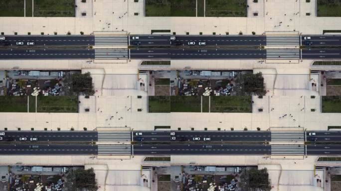 全景的道路从右到左，人们穿过人行横道，汽车站在交通堵塞，俯视图