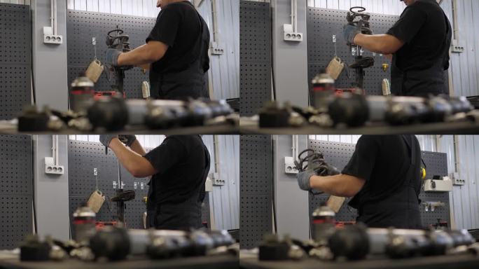 在汽车维修站修理汽车减震器的机械师。他移开弹簧