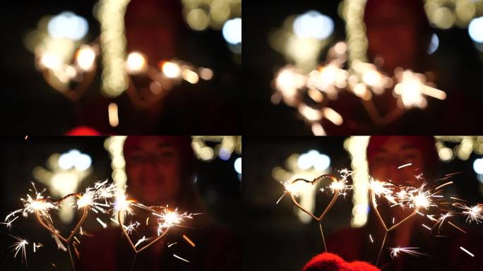 戴着红帽子的快乐微笑的女人站在街上，手里拿着壁炉形的烟花。孟加拉灯，喜庆的feyerferk。冬乐圣