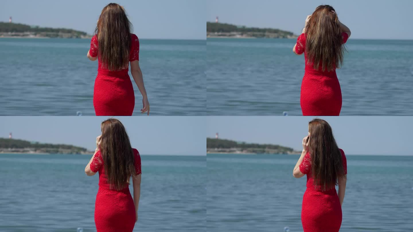 穿红衣服的女人在海边打电话