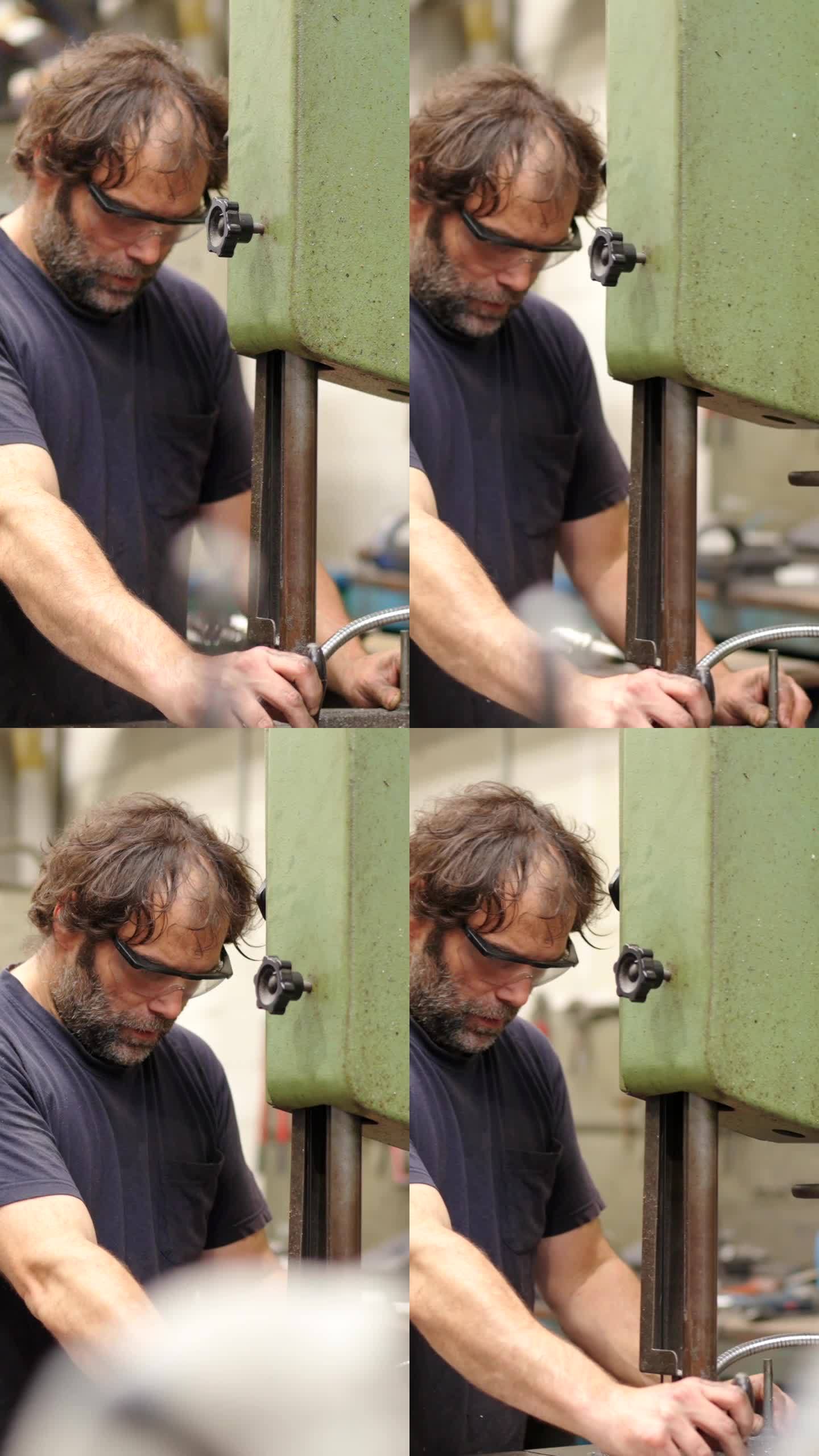 工厂里戴着护目镜使用机器的工人
