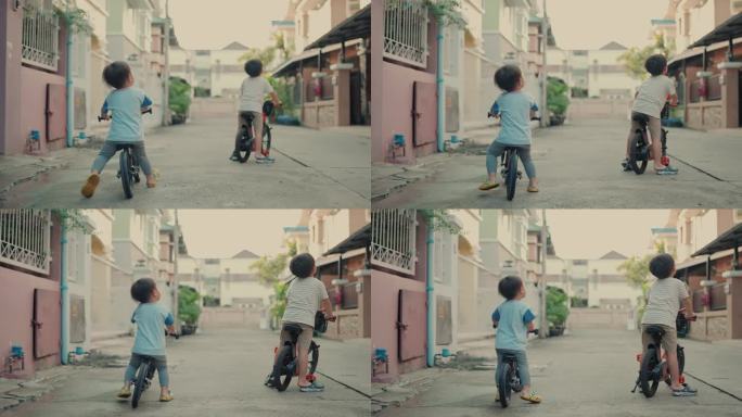 精力充沛的亚洲兄弟在城市骑小自行车:积极的家庭乐趣和学习。