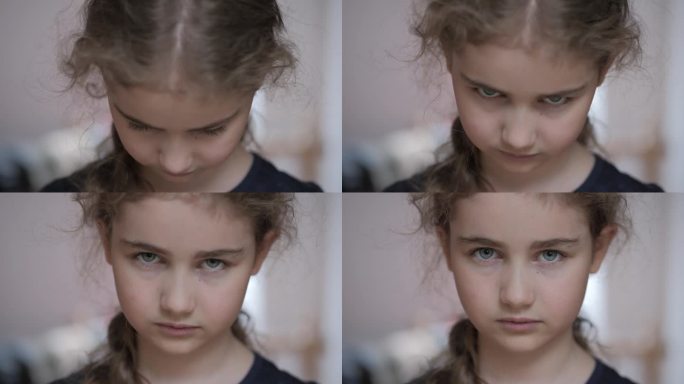 悲伤的思考好奇的孩子看着相机。脸眼睛严肃沉思的女孩。沮丧的女学生的肖像，悲伤，坏心情。沮丧的脸。童年