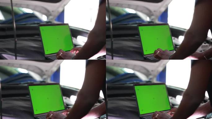 汽车维修技师女用绿屏笔记本电脑模拟色度键汽车诊断软件。汽车扫描仪计算机诊断。汽车电子诊断