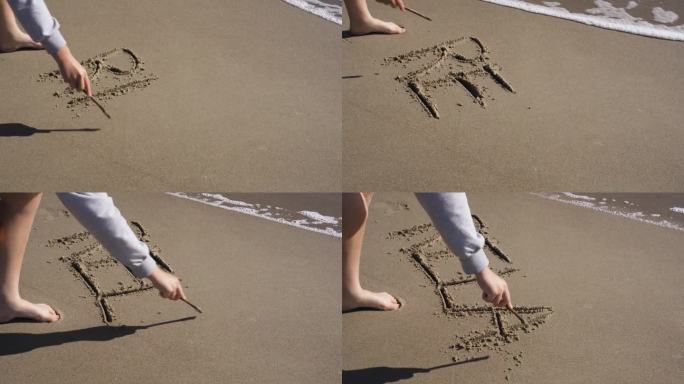 女孩在沙滩上写下了“放松”这个词。