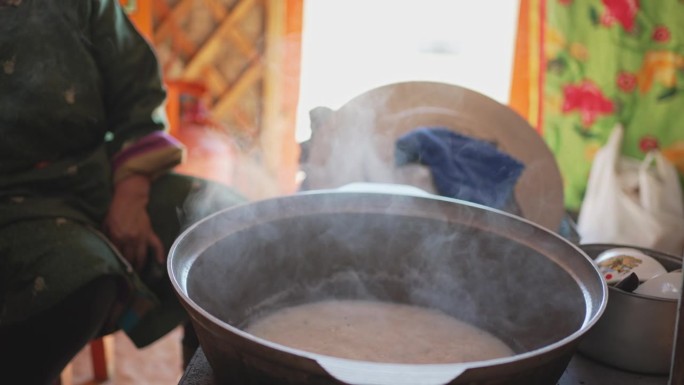 蒙古包内，蒙古族牧民妇女为客人准备传统奶茶