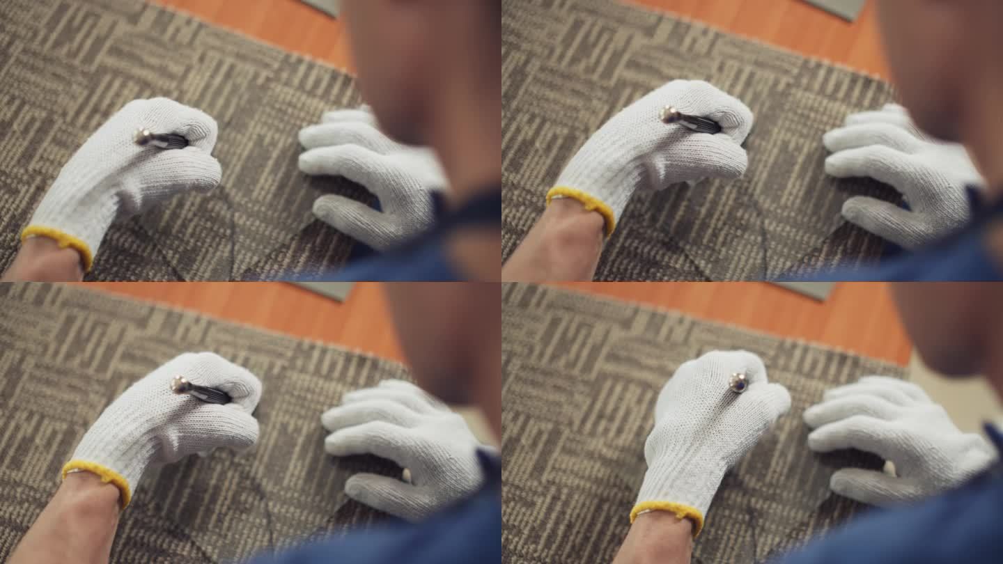 戴手套的工匠用玻璃刀在材料上工作