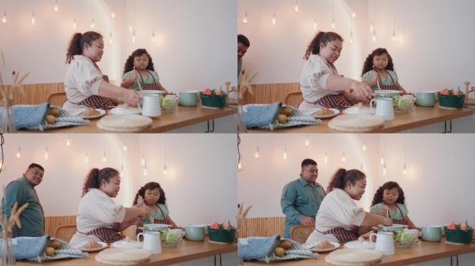 快乐的亚洲家庭在现代厨房一起烹饪，用爱和笑声准备新鲜的沙拉。