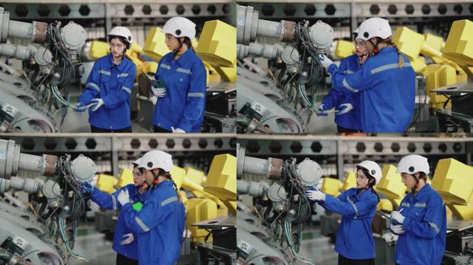 两名女工程师在仓库检查机械臂进行维修。
