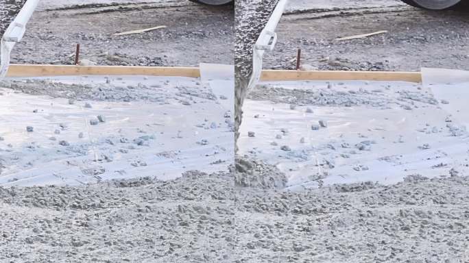工地工人用滑塌混凝土搅拌铲平整车道混凝土