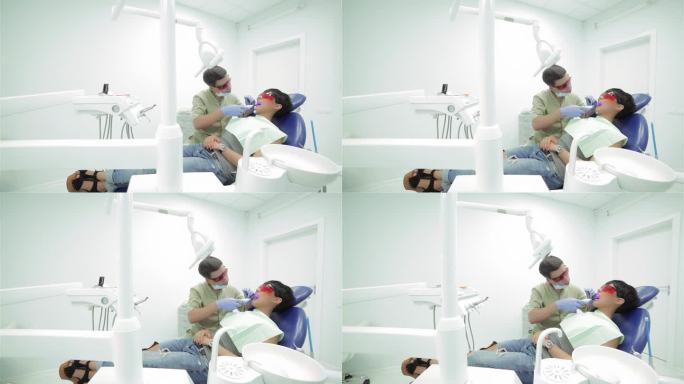 牙医在固定时照射紫外线光聚合物密封件
