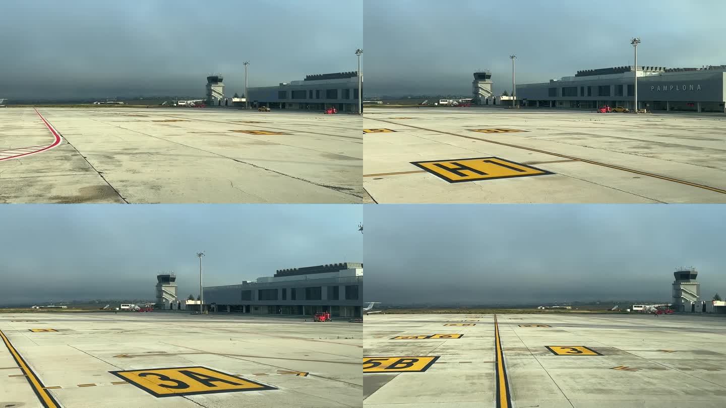 在一个寒冷的冬日清晨，飞行员在抵达西班牙潘普洛纳机场后，在机场的坡道上征税。