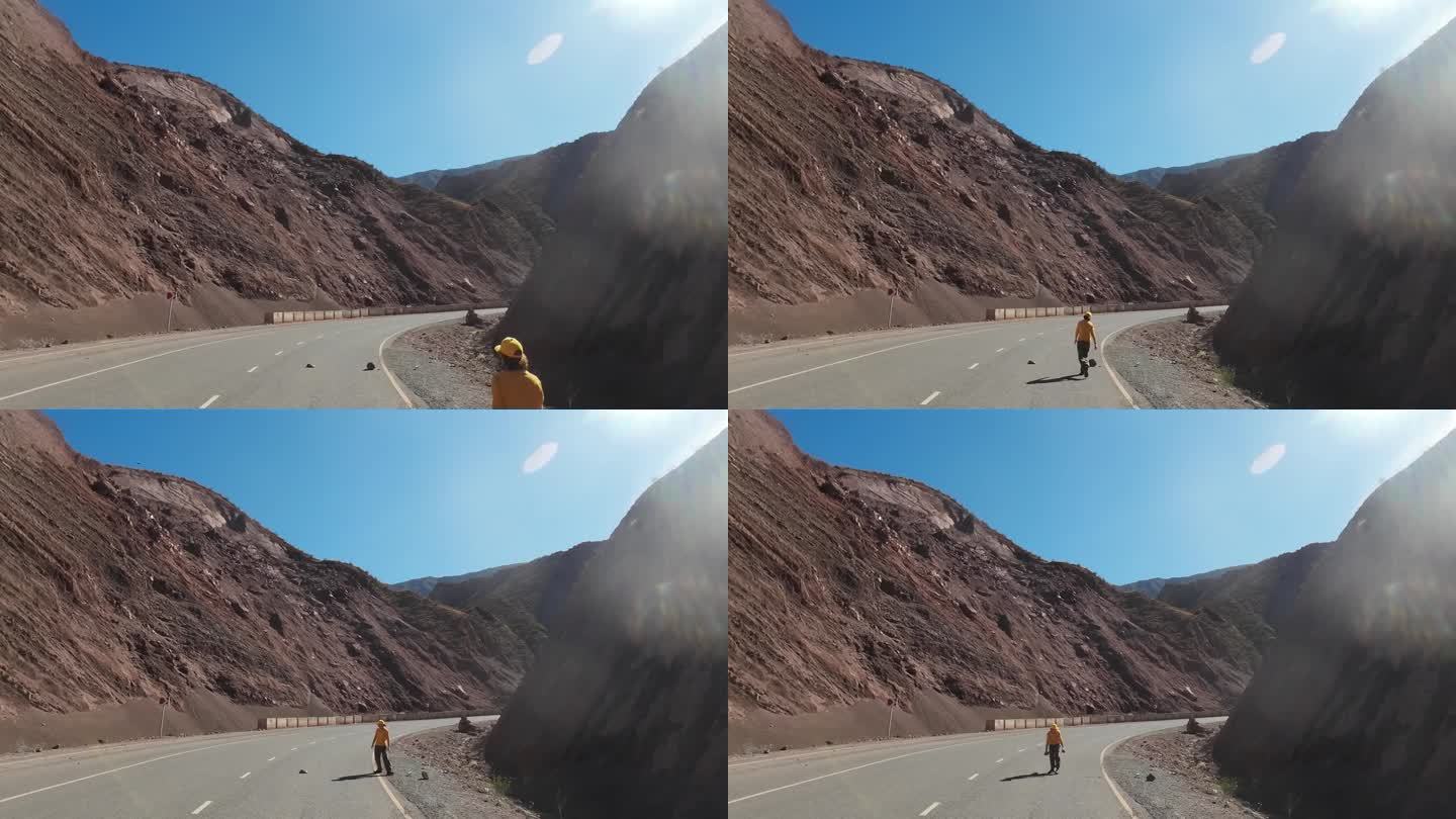 女人正在从山路上搬石头。汽车的观点
