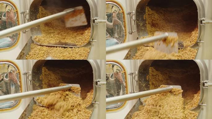 精酿啤酒生产厂，啤酒厂制造。将大麦麦芽颗粒放入传送带中特写。用金属瓶酿造、烹饪酒精。