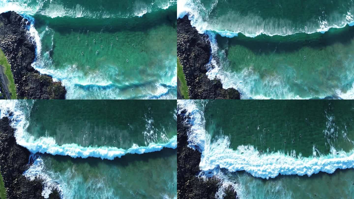 无人机空中景观鸟瞰冲浪者鸭子潜水划桨出海排队海浪膨胀岩石岬角海底沙洲基亚马海滩旅游新南威尔士州澳大利