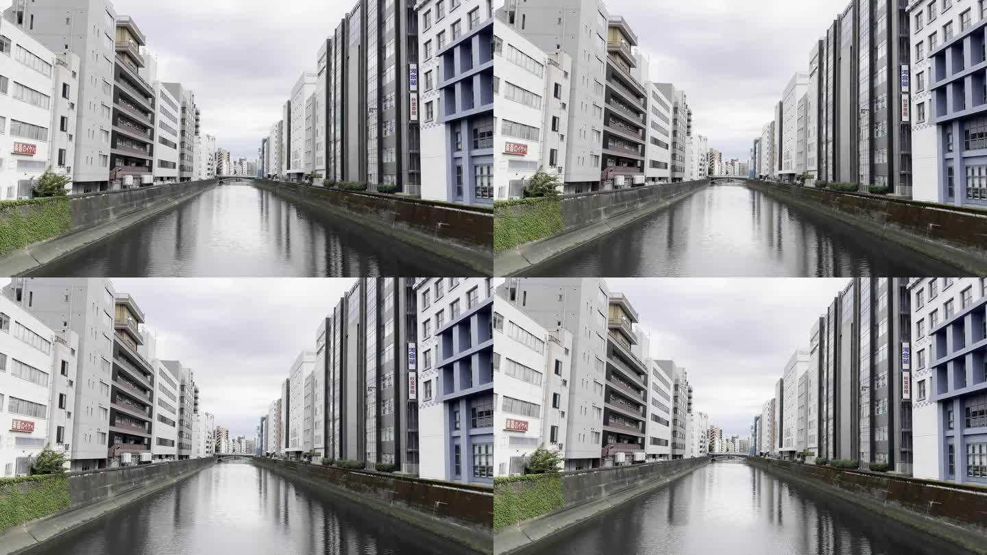 东京宽水渠周围现代建筑的壮丽景色:对称镜头与添加文字和图形的空间