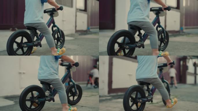 户外探险:精力充沛的男婴在充满活力的城市环境中练习骑自行车技能。