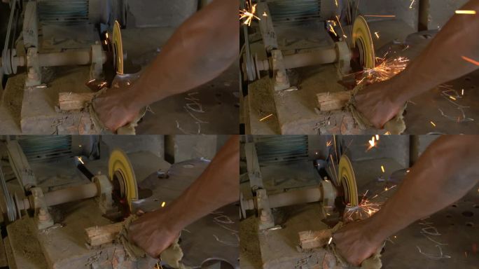 非洲工人正在打磨锯子，擦出火花，近距离拍摄他的手艺