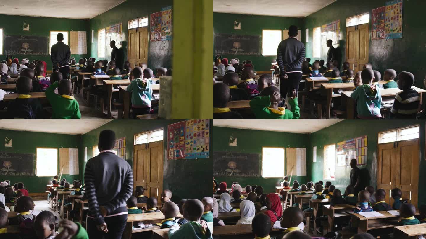 从门口看到孩子们在教室里的手持照片。男孩和女孩在学校学习。他们在教育大楼里。