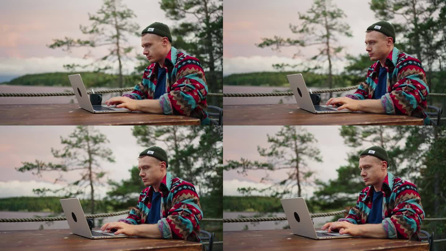 一名自由职业者早上用笔记本电脑工作，坐在大房子的露台上，在线教育